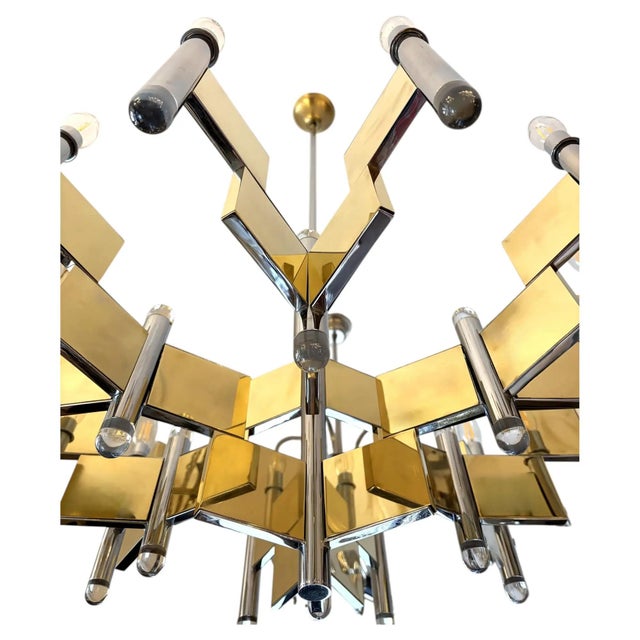 Italian Mid-Century Gaetano Sciolari chandelier is made of chrome and brass with with acrylic elements-ends. This...