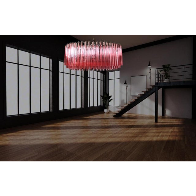 A magnificent Murano glass chandelier, 391 pink triedri on crome frame. This large Mid-Century Italian chandelier is truly...