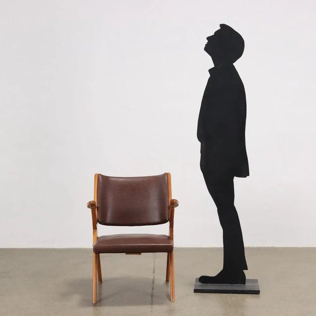 Armchair, foam padding, skai covering, beech wood structure. This piece is attributed to the mentioned designer/maker. It...