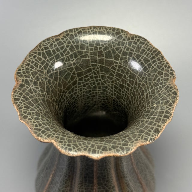Classic Chinese official‑style celadon lobed vase, featuring elegant scalloped flower‑shaped rim and distinct melon‑ribbed...