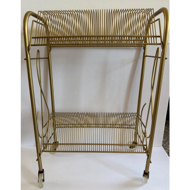 This is new in the box never used record rack. Gold tone Mid Century Modern album holder.