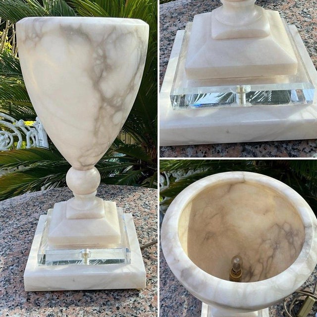 A substantial italian-style neoclassical table lamp crafted from beautifully veined white alabaster and raised upon a...