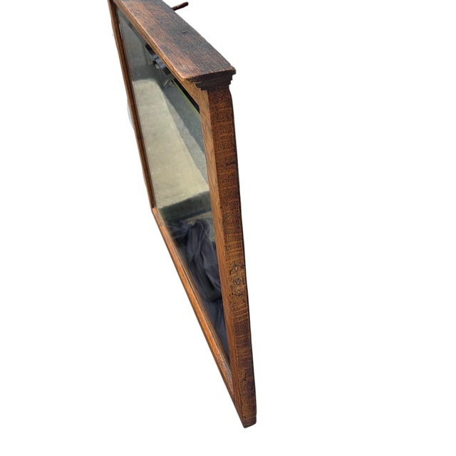 The Arts and Craft American solid oak Mirror is an antique piece from the early 20th century, featuring a rectangular...