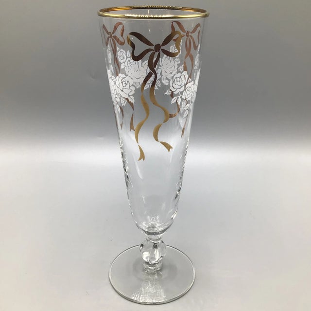 Get ready to celebrate the holidays with these Libbey Celebration white floral and gold ribbon champagne flutes.