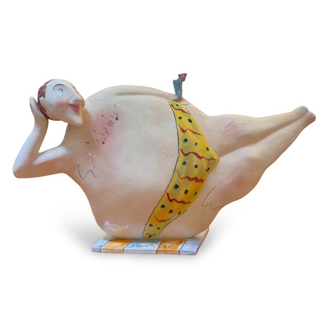 Signed 1990s whimsical art pottery teapot by Steven McGovern. The teapot depicts a reclining man in a bathing suit, ready...
