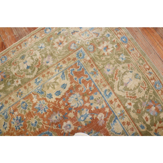 An early 20th-century oversize decorative Chinese rug with an all-over design on a faded peach field accents in brown,...