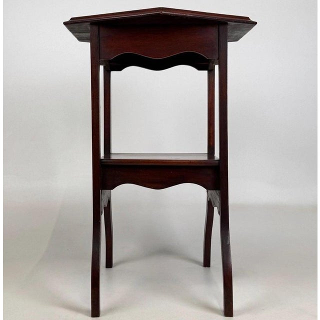 A charming early 20th-century English Edwardian side table, finely crafted from mahogany and distinguished by its elegant...