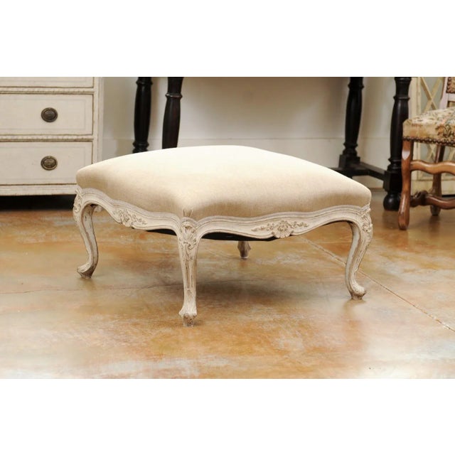 A Swedish Rococo style painted wood stool from the 19th century, with carved shells and newer upholstery. Created in...