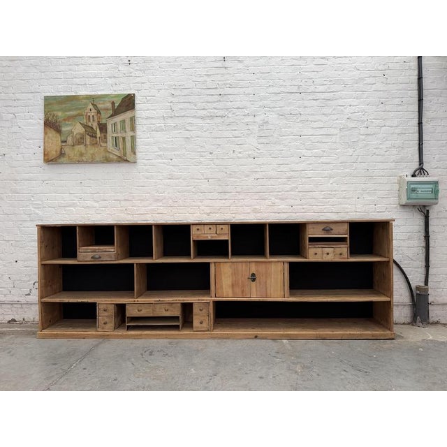 This massive pine workshop cabinet has been fully restored. It features 14 functional drawers of various sizes and...