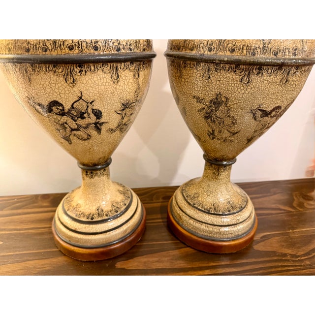 Pair of large decorative vases by Theodore Alexander, handmade in Vietnam. Each features an ivory crackle finish with...