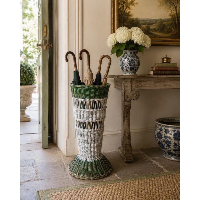 A charming late 19th century painted wicker umbrella basket with a beautifully weathered green and white surface. The tall...