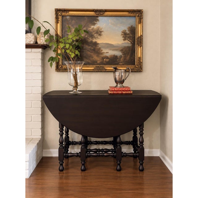 Authentic Kittinger Furniture Co. gateleg/drop-leaf table, crafted in Buffalo, New York. The table retains its original...
