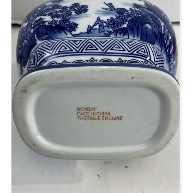 Elegant vintage porcelain vase by The Bombay Company featuring a classic blue and white Chinoiserie design. This...