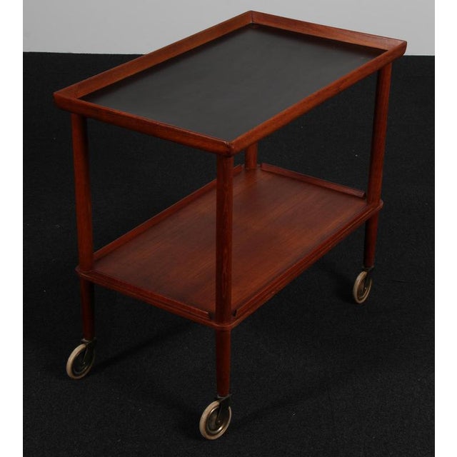 Søborg Møbler bar cart in teak mounted on wheels. with brass details. This piece is attributed to the mentioned...