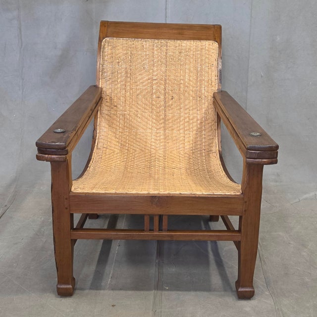 A classic vintage 1950s teak plantation lounge chair with a taught herringbone hand-caned seat and backrest. As with this...