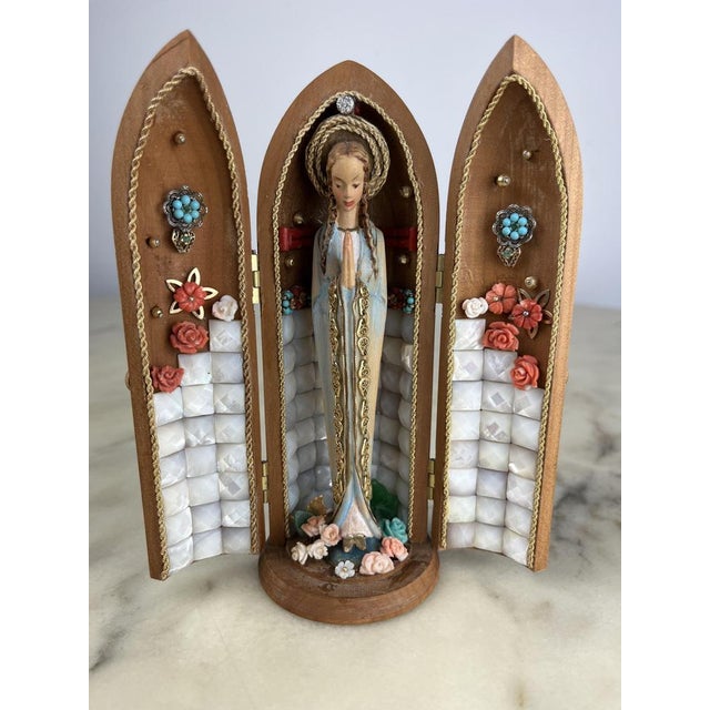 Statuette of the Madonna embellished with 18 kt gold and precious stones, Italy, 1980. Made by a goldsmith artisan who...