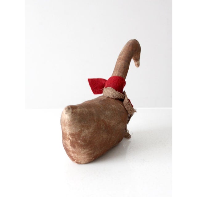 This vintage handmade primitive goose features a painted canvas body with a softly worn appearance and muted tones. Red...