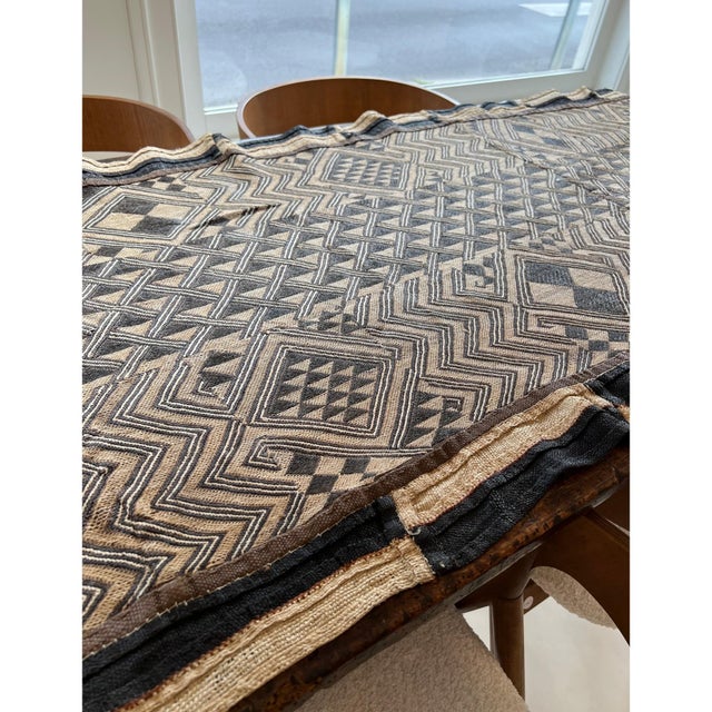 Crafted from authentic Kuba cloth, this long runner showcases the rich texture, intricate geometric patterns, and...