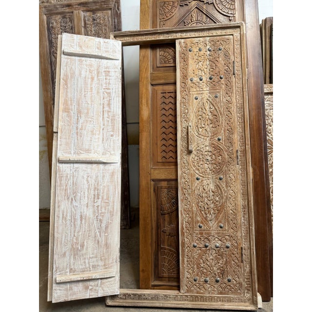 Elevate your space with these magnificent Antique Indian Hand-Carved Double Doors, a rare architectural salvage piece rich...