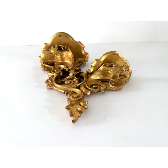 Gorgeous Florentine Italian double shelf wall bracket. Classic Italian craftsmanship with a beautiful golden shine from...