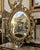 Make a striking statement with this grand French Rococo–style oval mirror, featuring an exceptionally ornate frame covered...