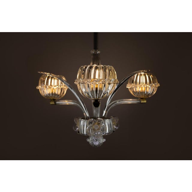 Barovier and toso chandelier in murano glass handmade by art deco master glass craftsmen in the 1940s. The exquisite three...