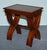 An elegant set of three mahogany nesting tables, each supported by sculptural lyre–form bases, elegantly joined by turned...