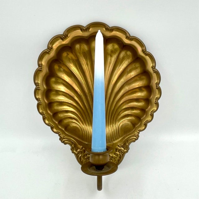 Vintage warm brass scallop shell-shaped candle wall sconce featuring a beautiful, age-earned patina. This classic piece...