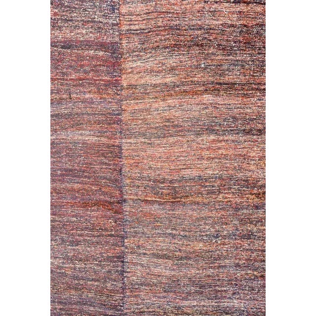 A fantastic vintage Persian Gabbeh Kilim rug woven in crimson and indigo wool with a simple whipstitched edge trim.