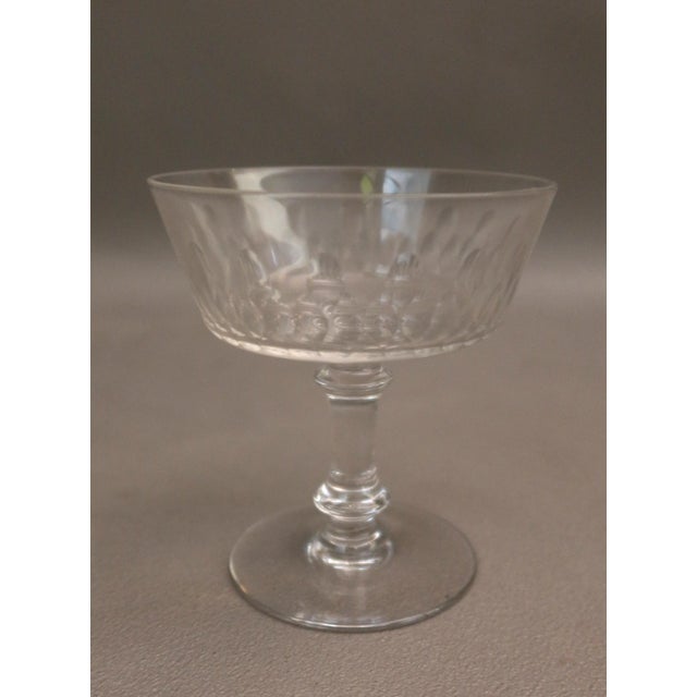 Set of twelve cut crystal champagne coupes, in very good condition. Dimensions: 10cm high, 9cm at the rim.