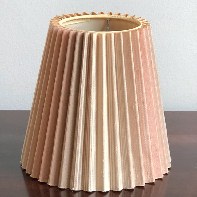 This petite mid-20th century lamp shade is very much "of the era" with its tall, elongated profile and earthy tones. This...