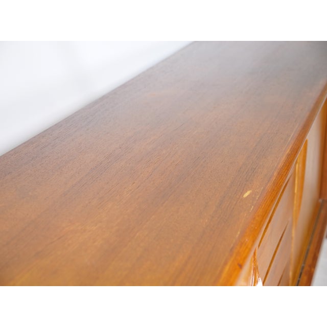 Large mid-century teak sideboard by Axel Christensen for ACO Møbler, 1960s. Very wide, low design with four sliding doors...