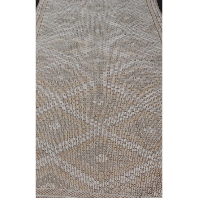 Measures: 6'4 x 11'8 This Vintage Turkish Kilim Gallery Runner is a stunning example of traditional craftsmanship,...