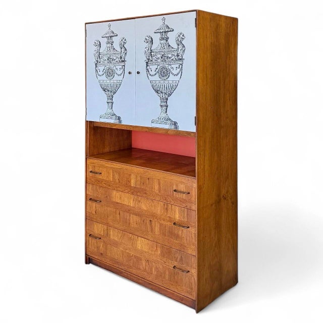 A 1970s cabinet by Lane in the manner of Fornasetti, the case of walnut parquetry and having two white laminate doors,...
