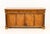 Italian Empire Walnut Commode a Vantaux, with three drawers above two cabinets between gilt metal and ebonized columns....