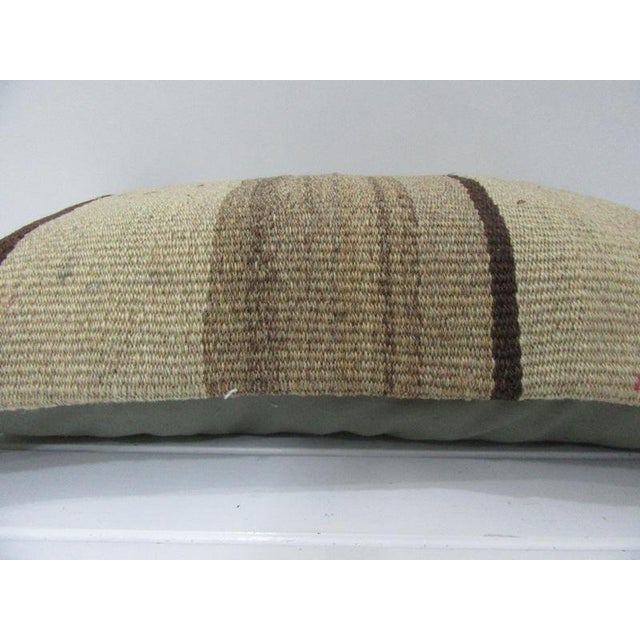 This is a pillow cover made from a vintage kilim rug. The piece was properly washed and ready to use. Pillow inserts not...