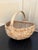 A beautifully woven early 20th century American splint oak basket with warm honeyed tones and a tightly constructed...