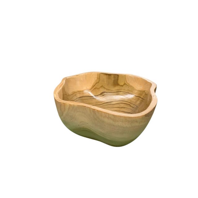 This teak live edge bowl is a unique piece showcasing the natural beauty of teak wood. Crafted by skilled artisans, its...