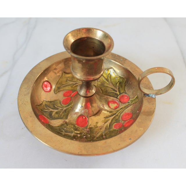 Vintage enameled brass candle holders with holly and berry motif. Made in India. Some age wear to painted finish. Pictured.