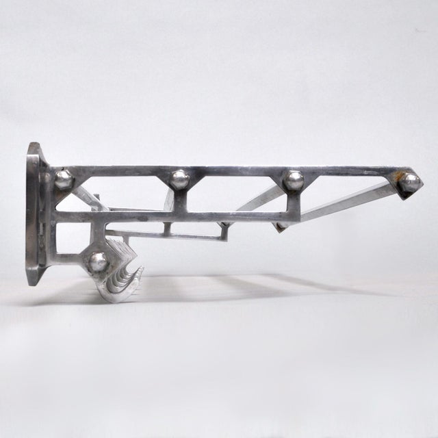 Vintage aluminum coat rack from the 1950s, featuring a distinctive industrial design. The lightweight yet sturdy frame is...