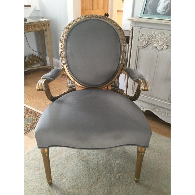 Inspired by the Louis XVI style, this updated version features a gold and silver carved frame with light grey upholstery....