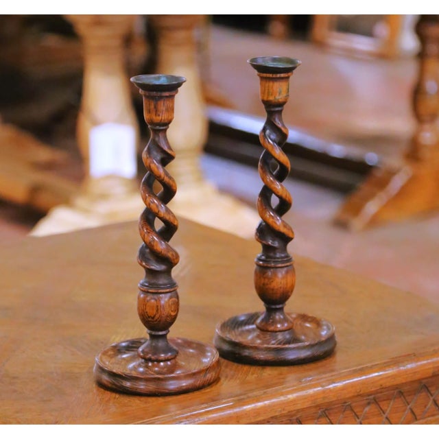 This elegant pair of antique candlesticks was crafted in England circa 1920. Each candle holder stands on a substantial...