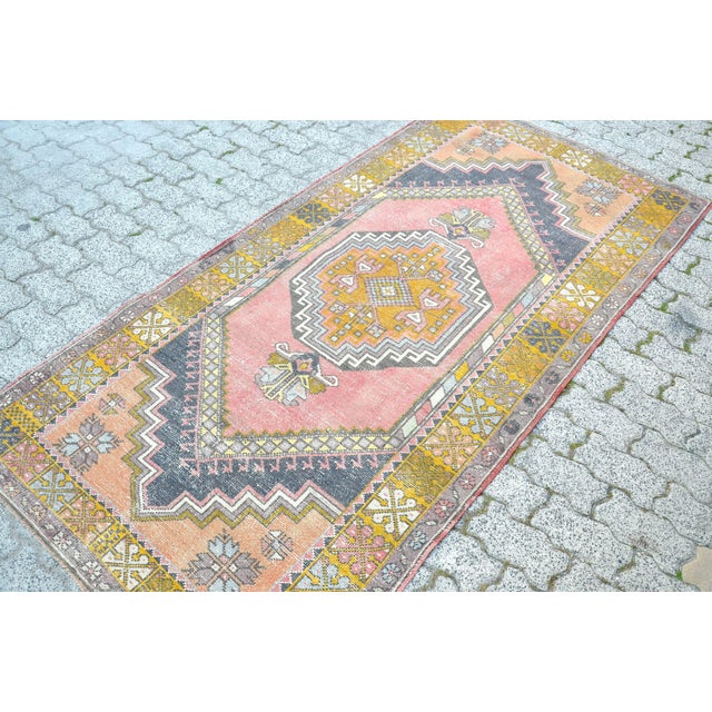 This is a vintage Turkish Oushak rug from the 1960s. The piece was hand-knotted.