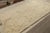 Hand-knotted in wool circa 1950-1960, this 6x11 vintage Moroccan rug is similar to Beni Ourain rugs in its minimalist...