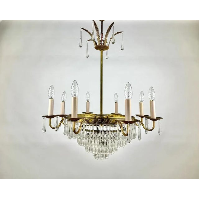 Luxurious Cascading Crystal And Brass Chandelier from France 1960s. Crystal and brass chandelier is the quality in every...
