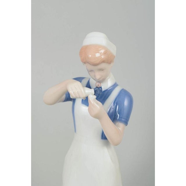 Bing & Grøndahl nurse figurine. Classic porcelain figurine model 2379 depicting a nurse in uniform, crafted in hand-...