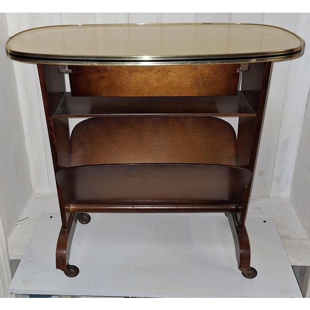 Mid-Century Modern German Side Table on Casters with Integrated Newspaper Rack, 1950s, in Very Good conditions. Designed...