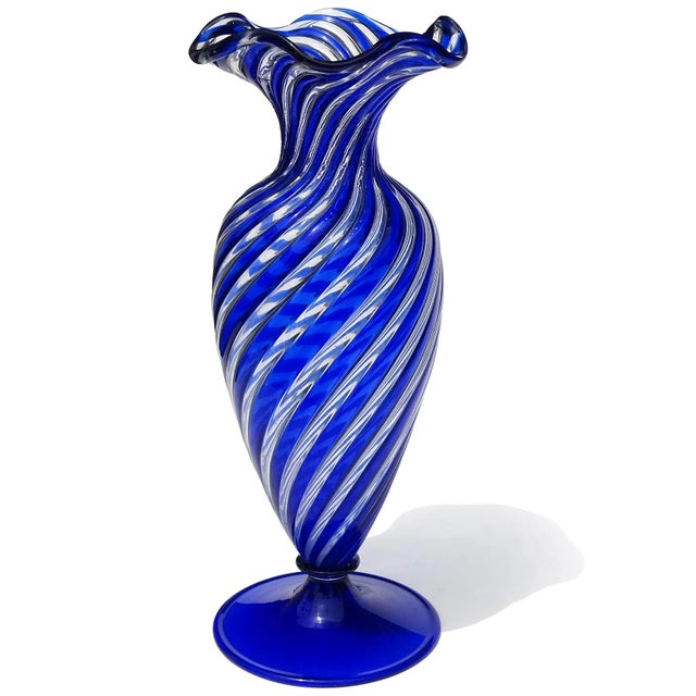 Beautiful vintage Murano hand blown sapphire blue and clear Italian art glass footed flower vase. Documented to the Arte...