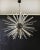 Sputnik chandelier from the 50s wtih crystal glass 'triedri' prisms radiating from the center black metal nucleus. It has...