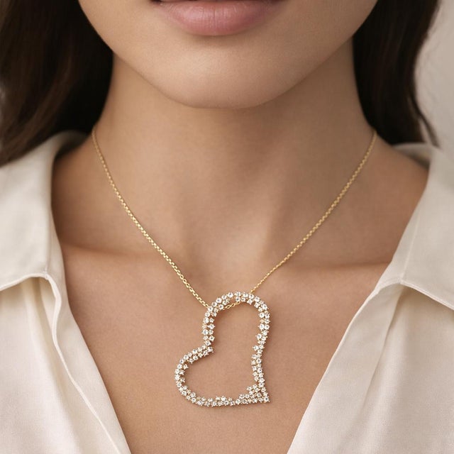 Beautiful 14K stamped yellow gold heart necklace featuring a large heart-shaped pendant set with natural diamonds,...